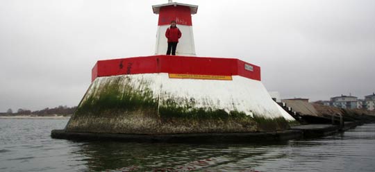 The breakwater and lighthouse at Lomma harbour - marked in green by waves